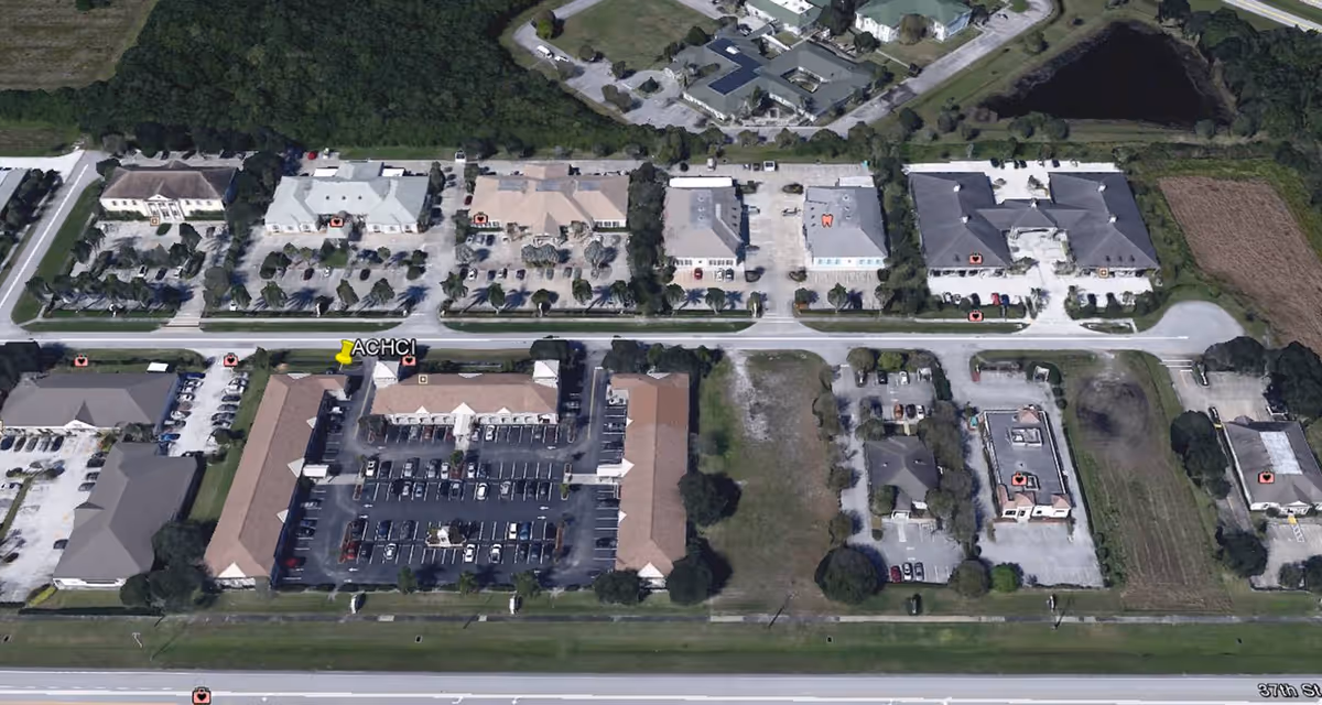 Aerial view of a senior care campus with multiple buildings and parking lots.