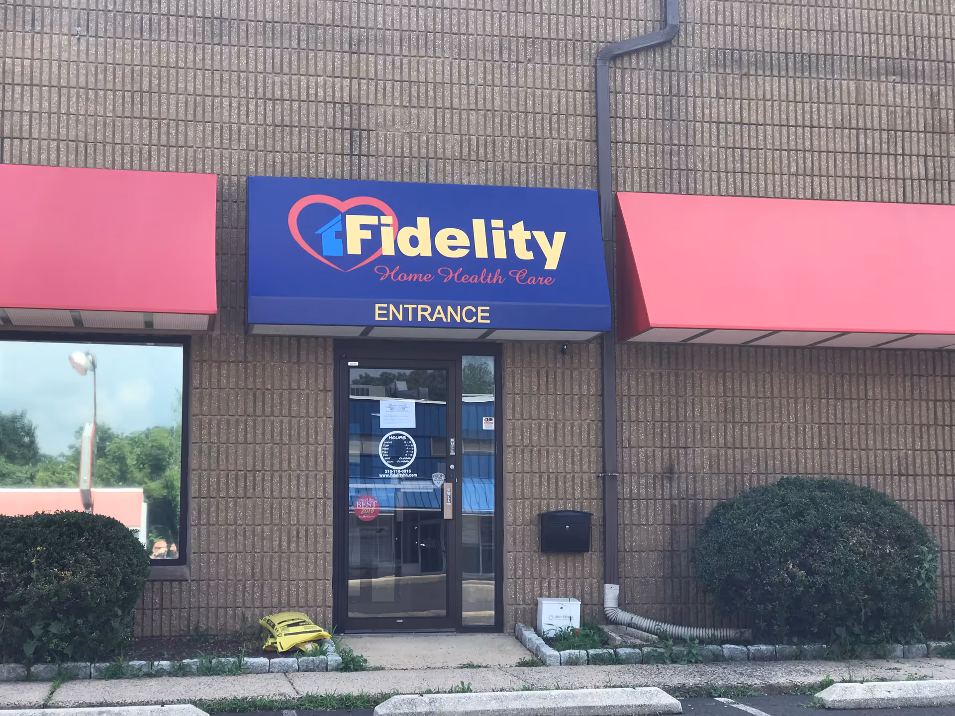 Front view of Fidelity Home Health Care entrance with blue sign and brick exterior.