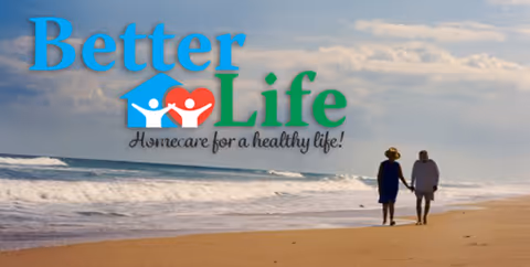 Two people walk along a sandy beach beside the ocean with a logo overlay.