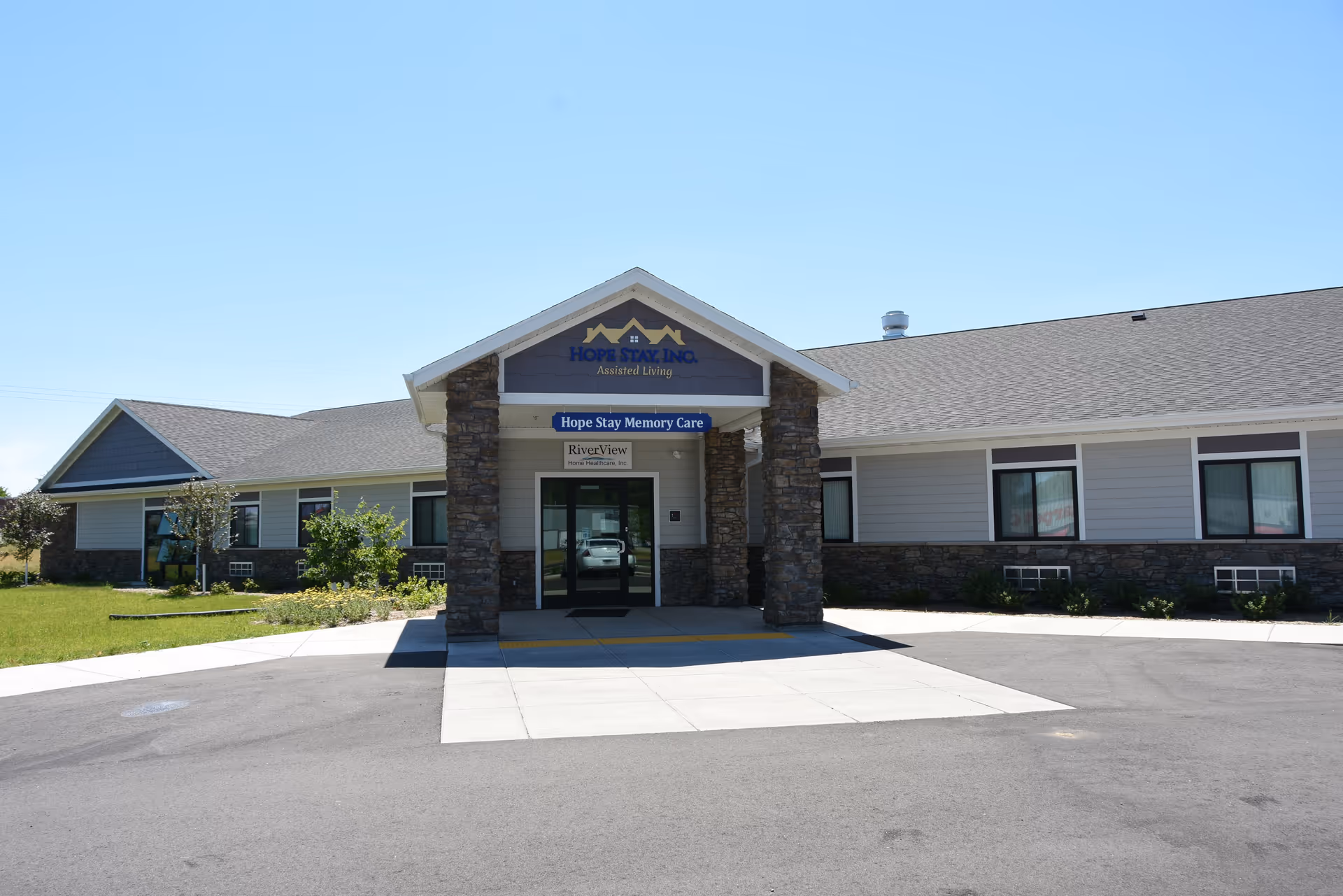 Front of Hope Stay Memory Care, a single-story facility with stone entrance and blue signage.