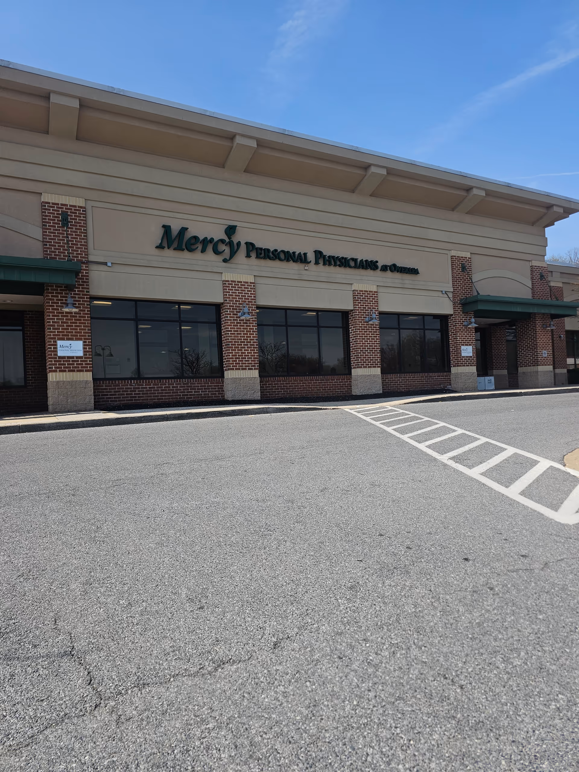 Exterior view of Mercy Personal Physicians at Overlea, brick-front building and parking lot.