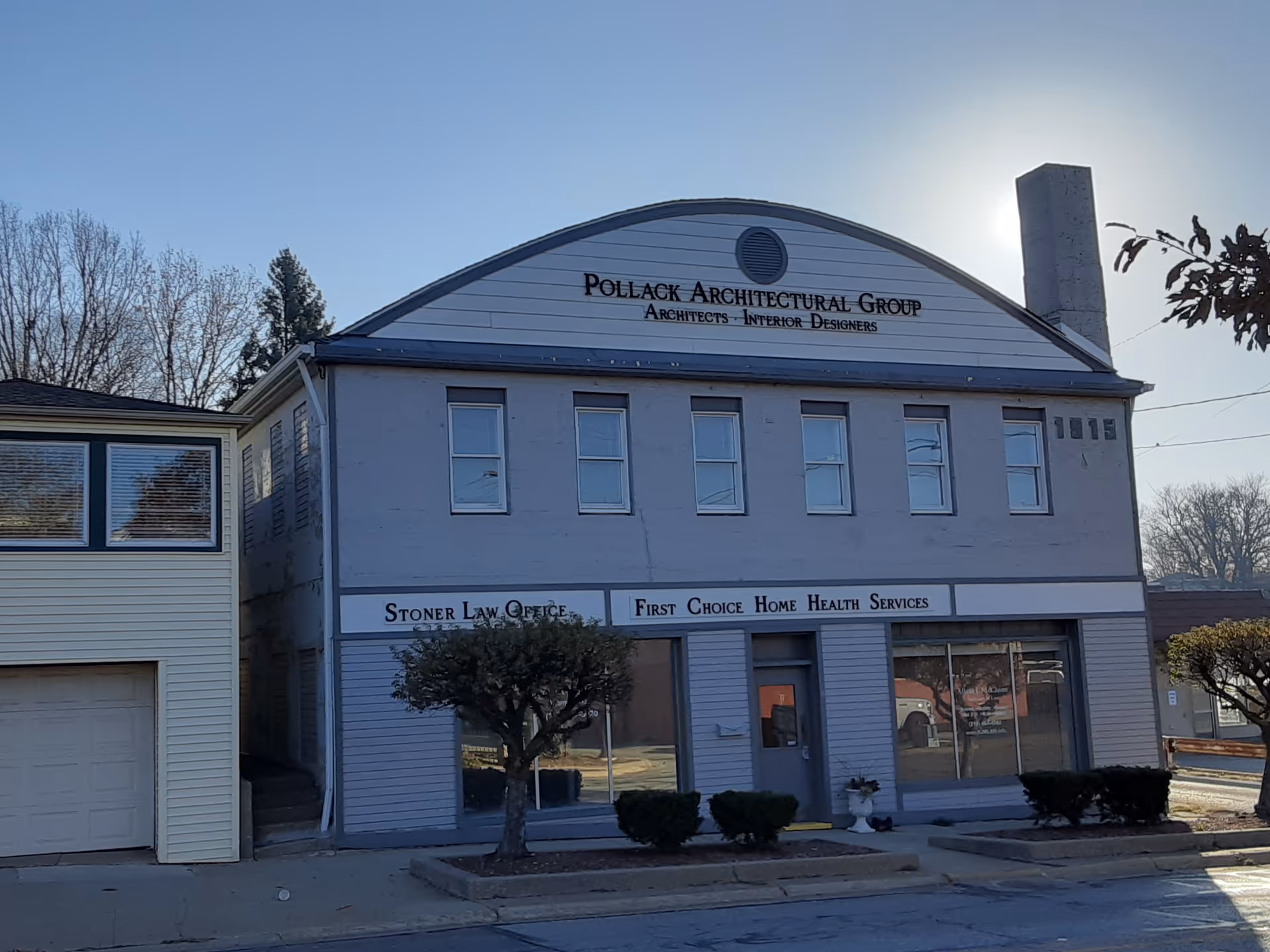 Two-story gray commercial building with First Choice Home Health Services sign on the front.
