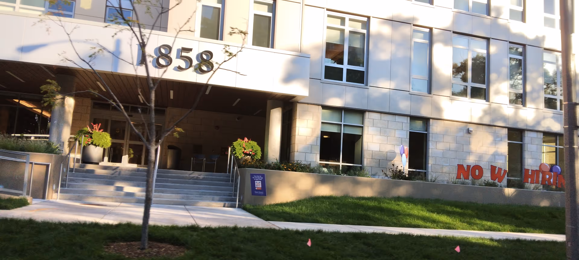Exterior view of Saint John's on the Lake Health Center building with steps, trees, and landscaping.