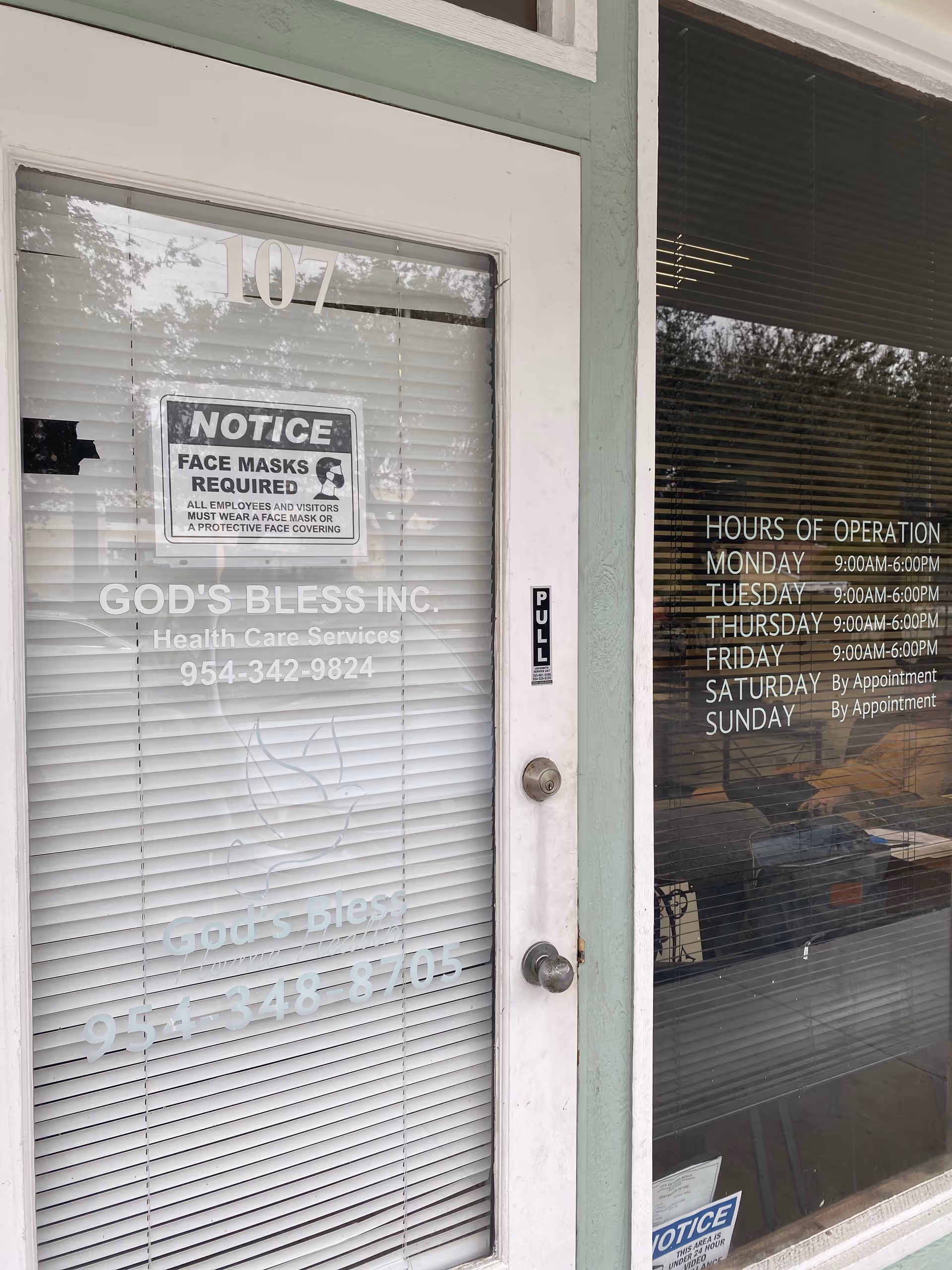 Front entrance of God's Bless Home Health with hours and notices on glass.