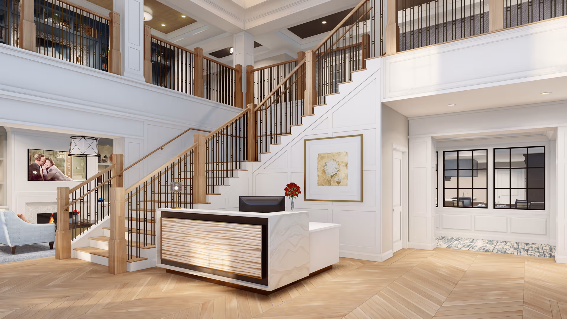 Bright reception lobby with a front desk, seating area, and a sweeping wooden staircase under a mezzanine.