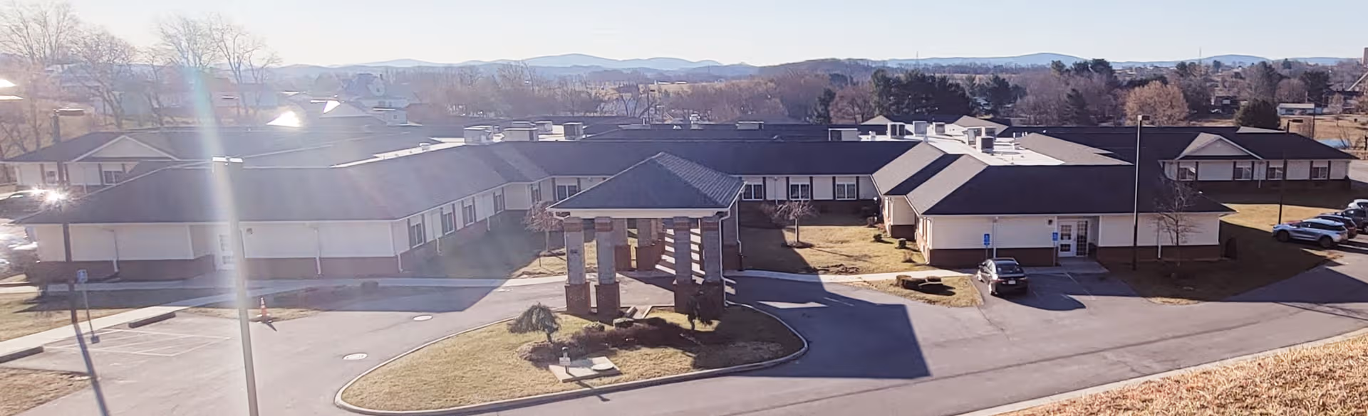 Exterior view of Mountain Laurel Rehab and Nursing campus with entrances, drive, and parking.