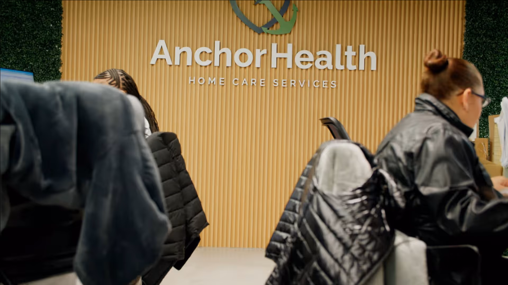 Interior lobby at Anchor Health Home Care Services with staff and visitors.