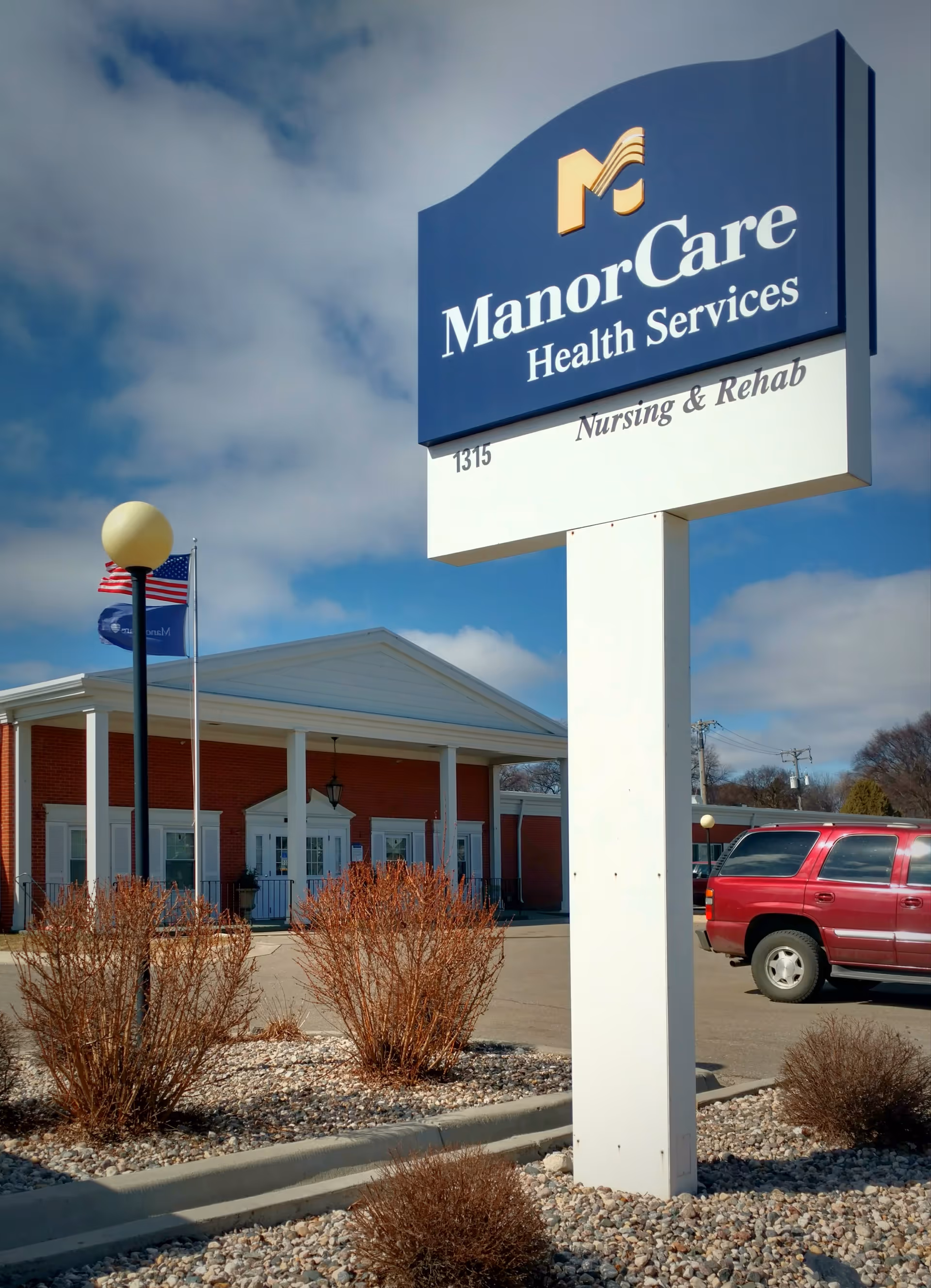 Exterior view of ManorCare Health Services sign with the building entrance.