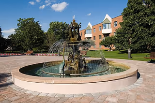 Outdoor courtyard at Southgate at Shrewsbury with a multi-tier fountain and brick paths