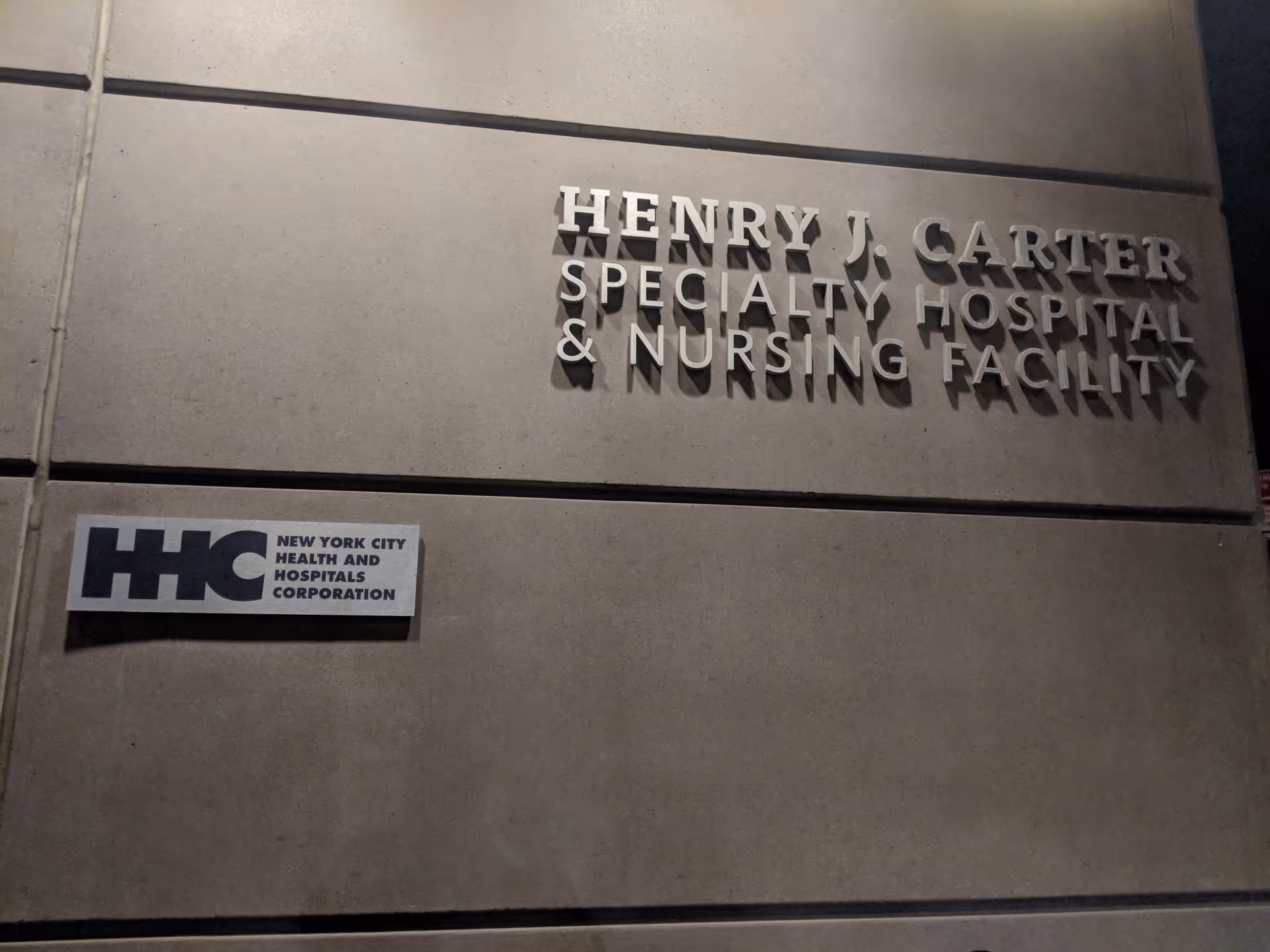 Exterior view of Henry J. Carter facility signage on concrete wall