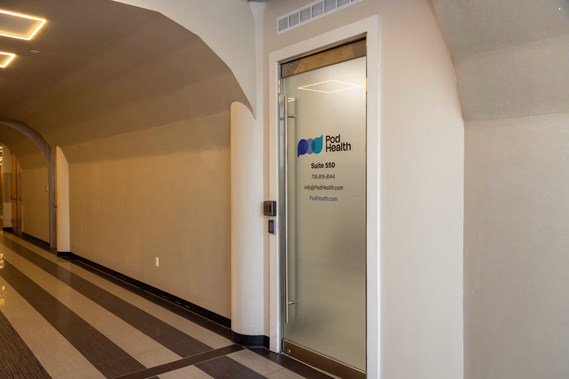 Interior hallway with frosted glass Pod Health door labeled Suite 550.
