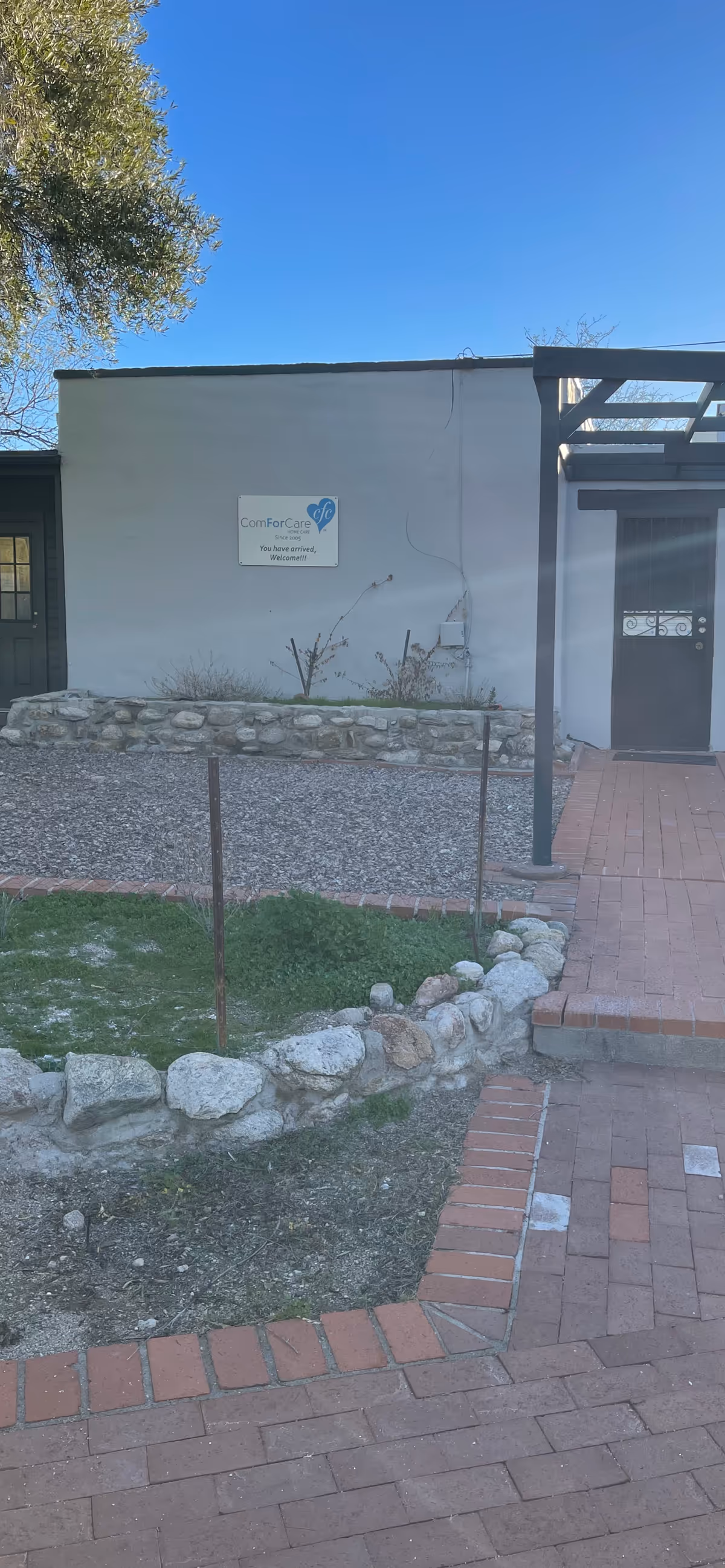 Exterior view of a ComForCare Home Care facility entrance with walkway and landscaping.