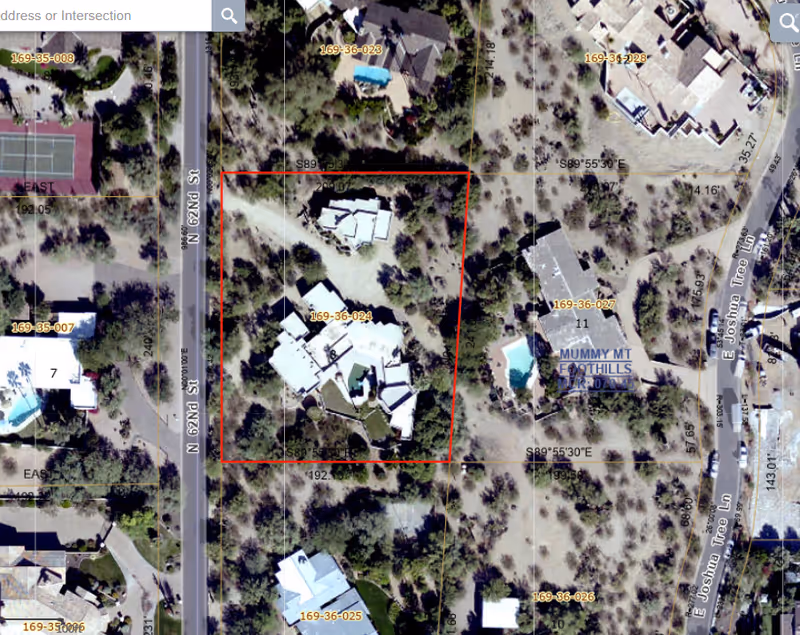 Aerial view of a property outlined in red within a residential desert neighborhood.