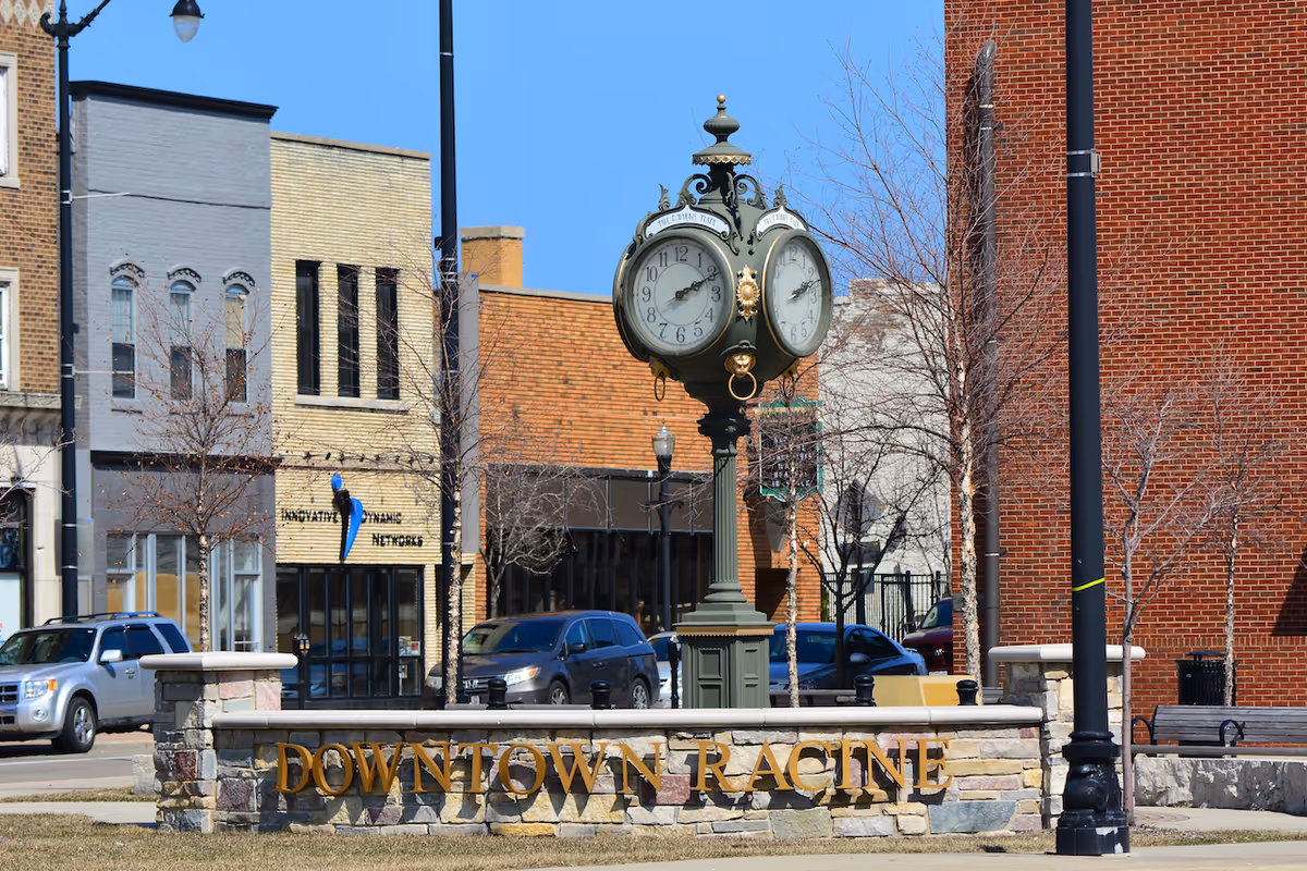Downtown Racine street scene with an ornate clock monument and storefronts.