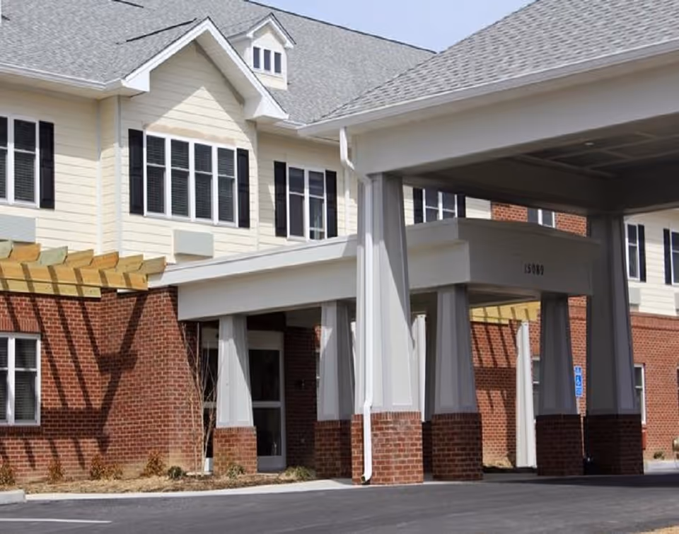 Exterior view of English Meadows Abingdon Campus main entrance with brick and siding columns.