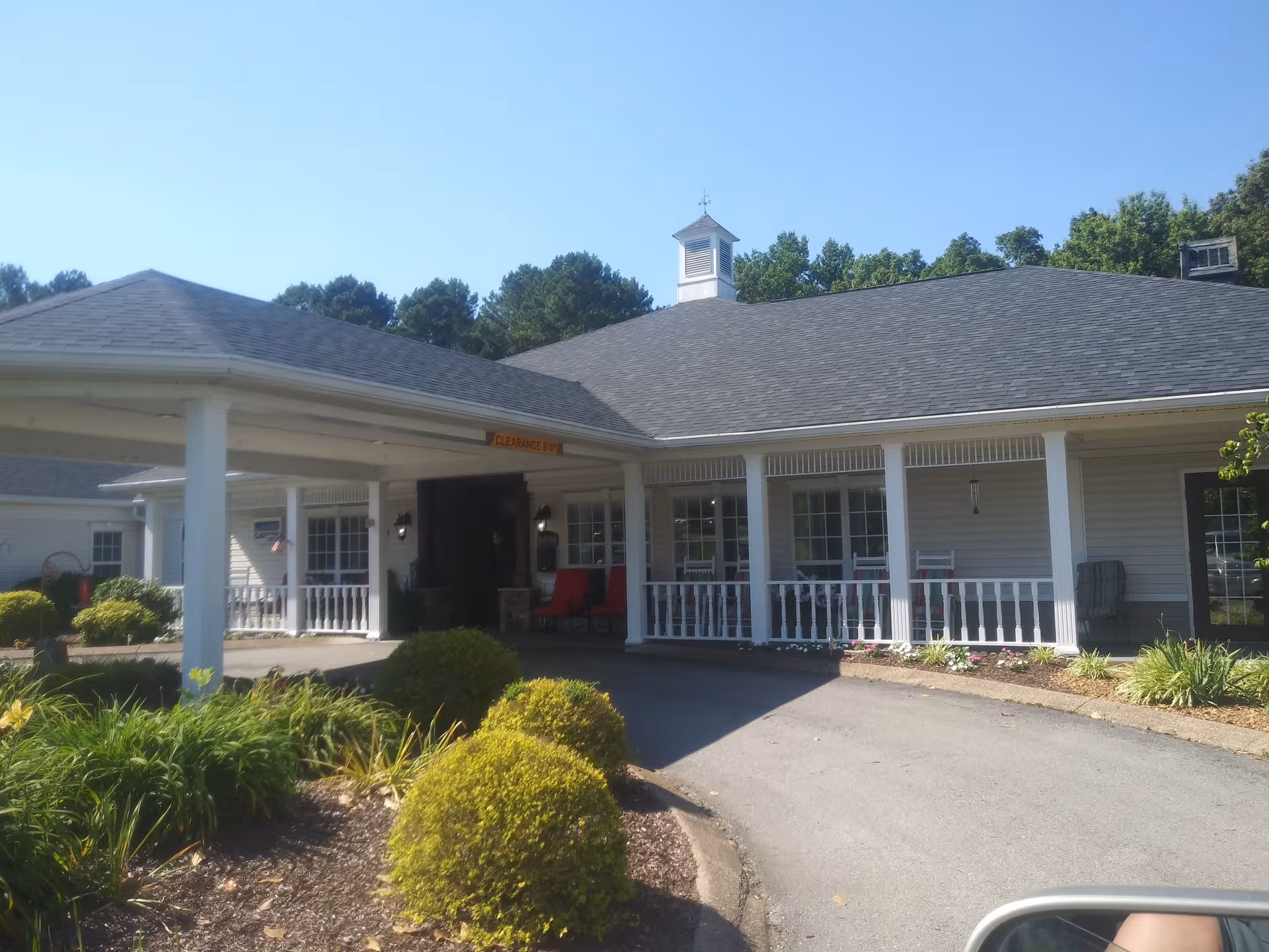 Exterior view of Summit of Lawrenceburg, a single-story senior living facility with a covered entrance.