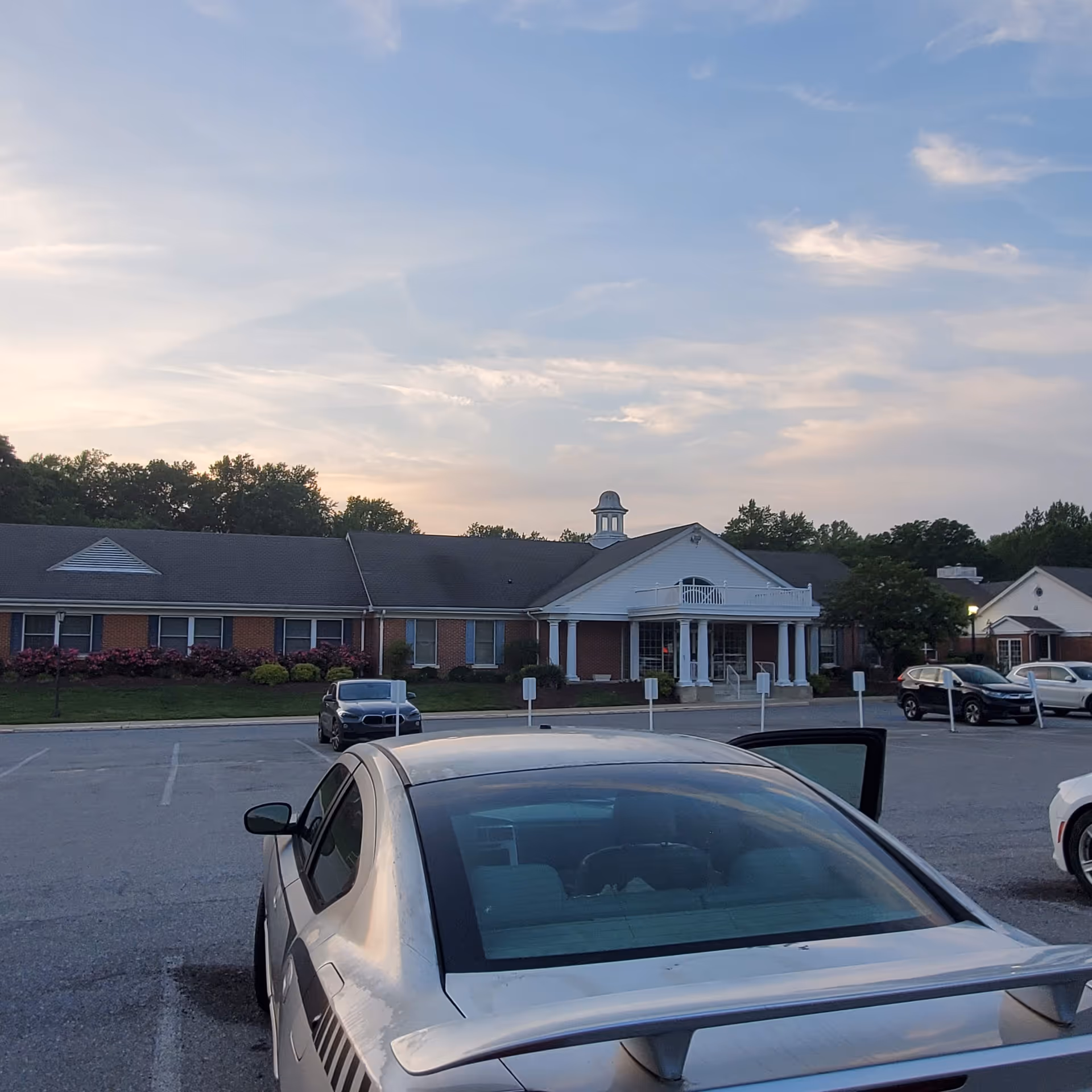 Front view of Sagepoint Memory Care exterior with cars parked in the lot