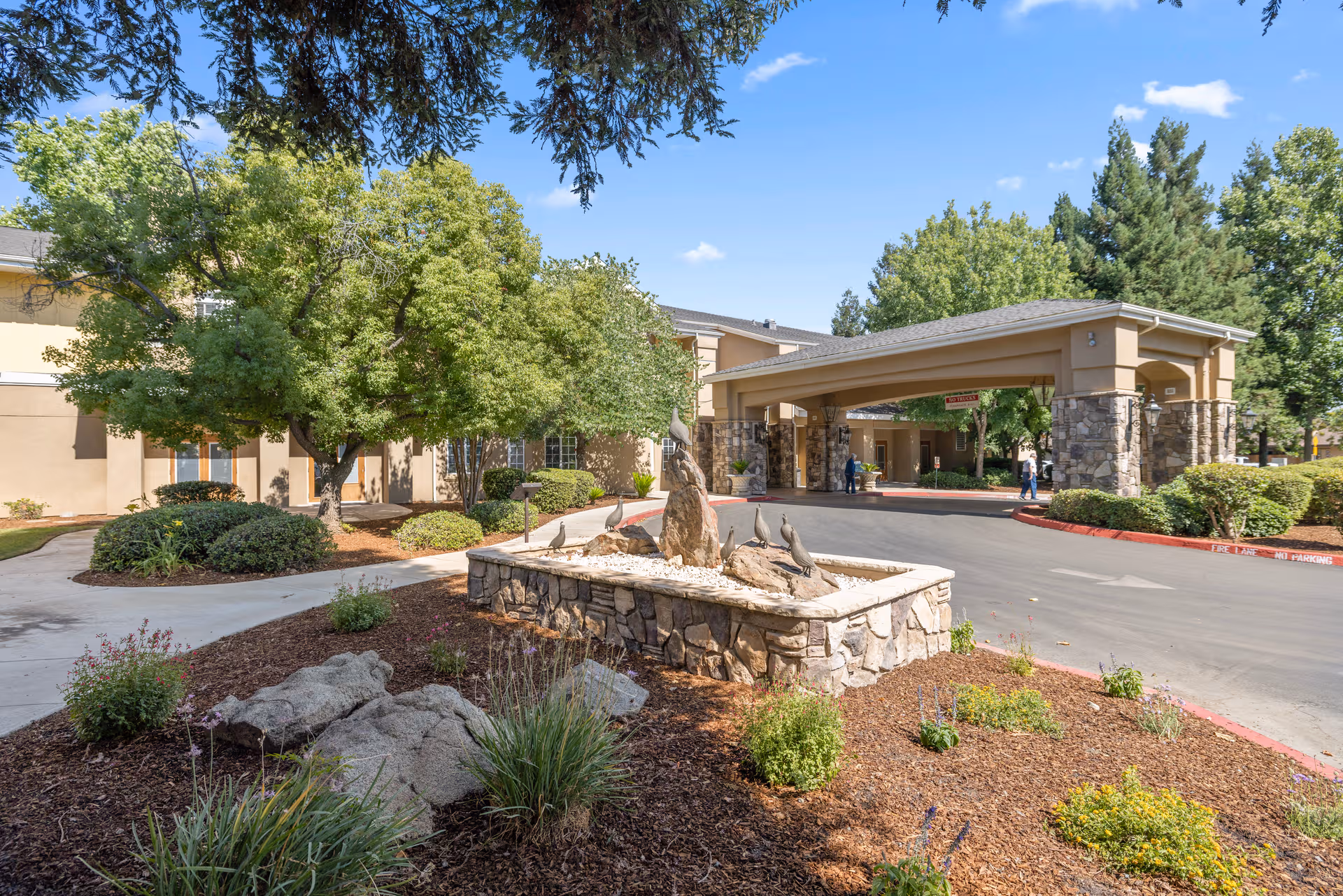 Exterior view of Quail Park on Cypress with entrance canopy and landscaping.