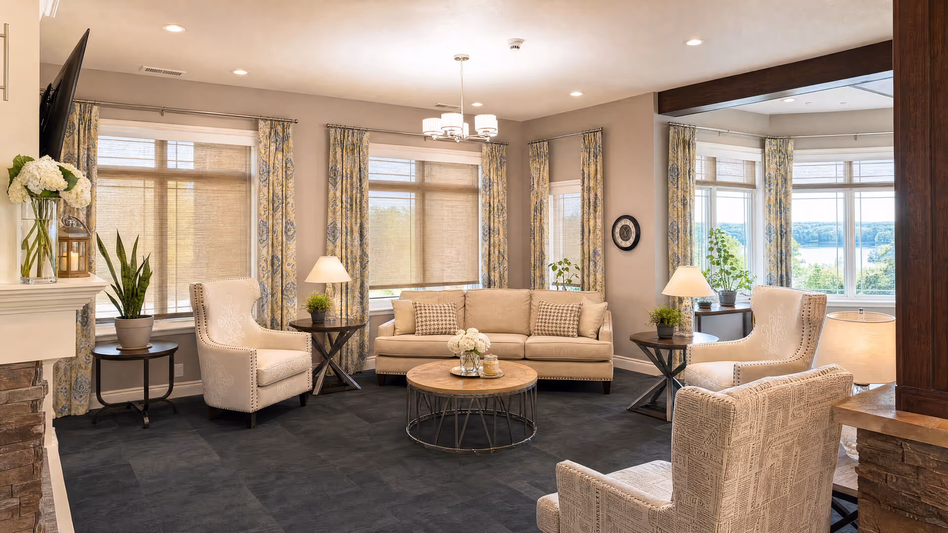 Bright living room with beige seating, coffee table, and large windows.