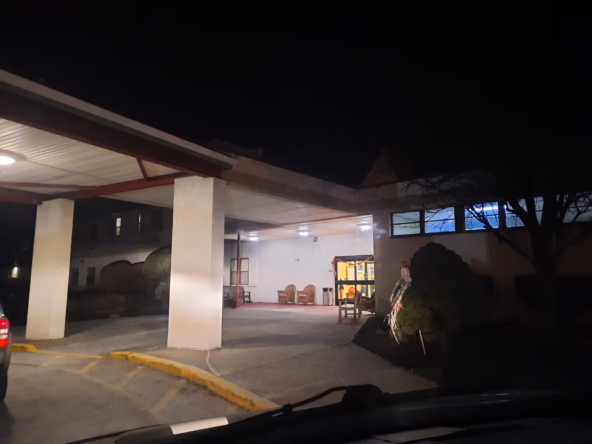 Night exterior view of Locust Grove entrance with a covered drop-off area.
