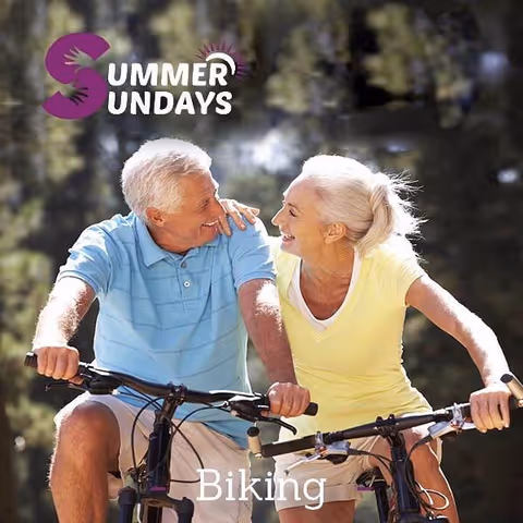Two seniors ride bicycles together outdoors, smiling, with Summer Sundays branding.