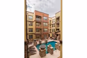 Outdoor courtyard at The View at Montecillo featuring a pool and lounge seating.
