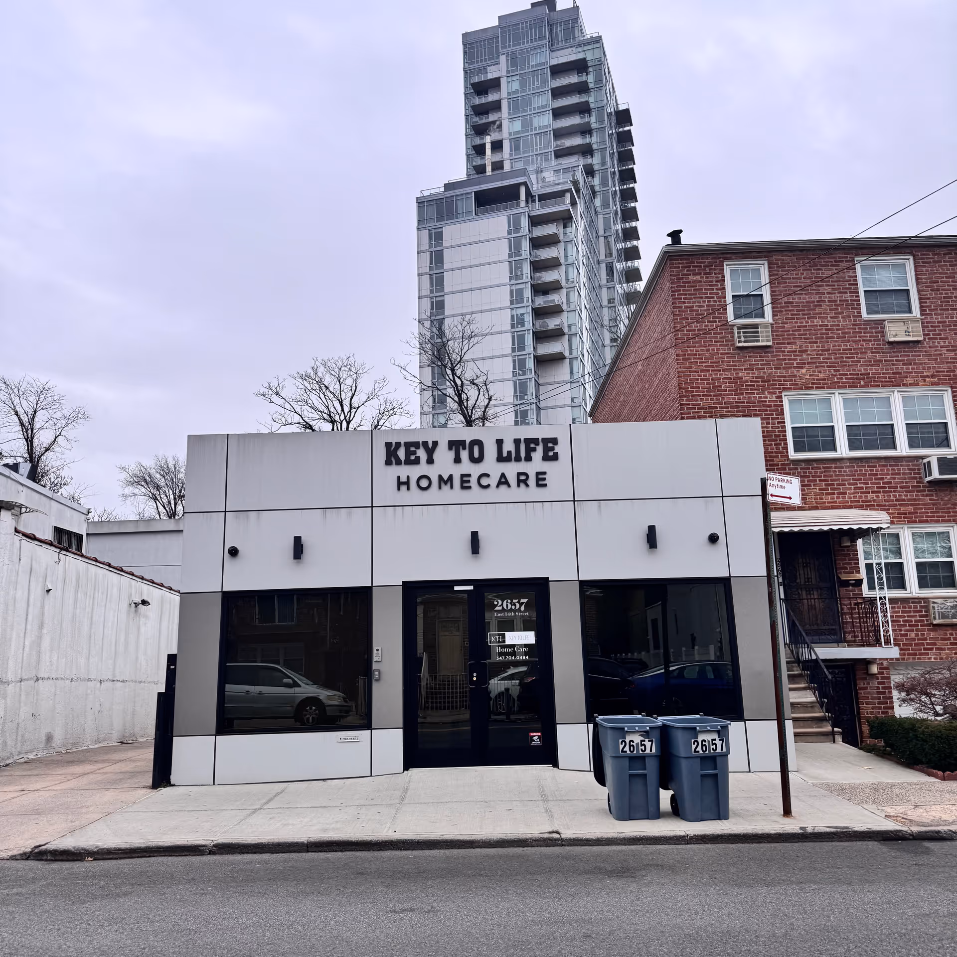 Front exterior of Key To Life Homecare storefront with a tall building behind.