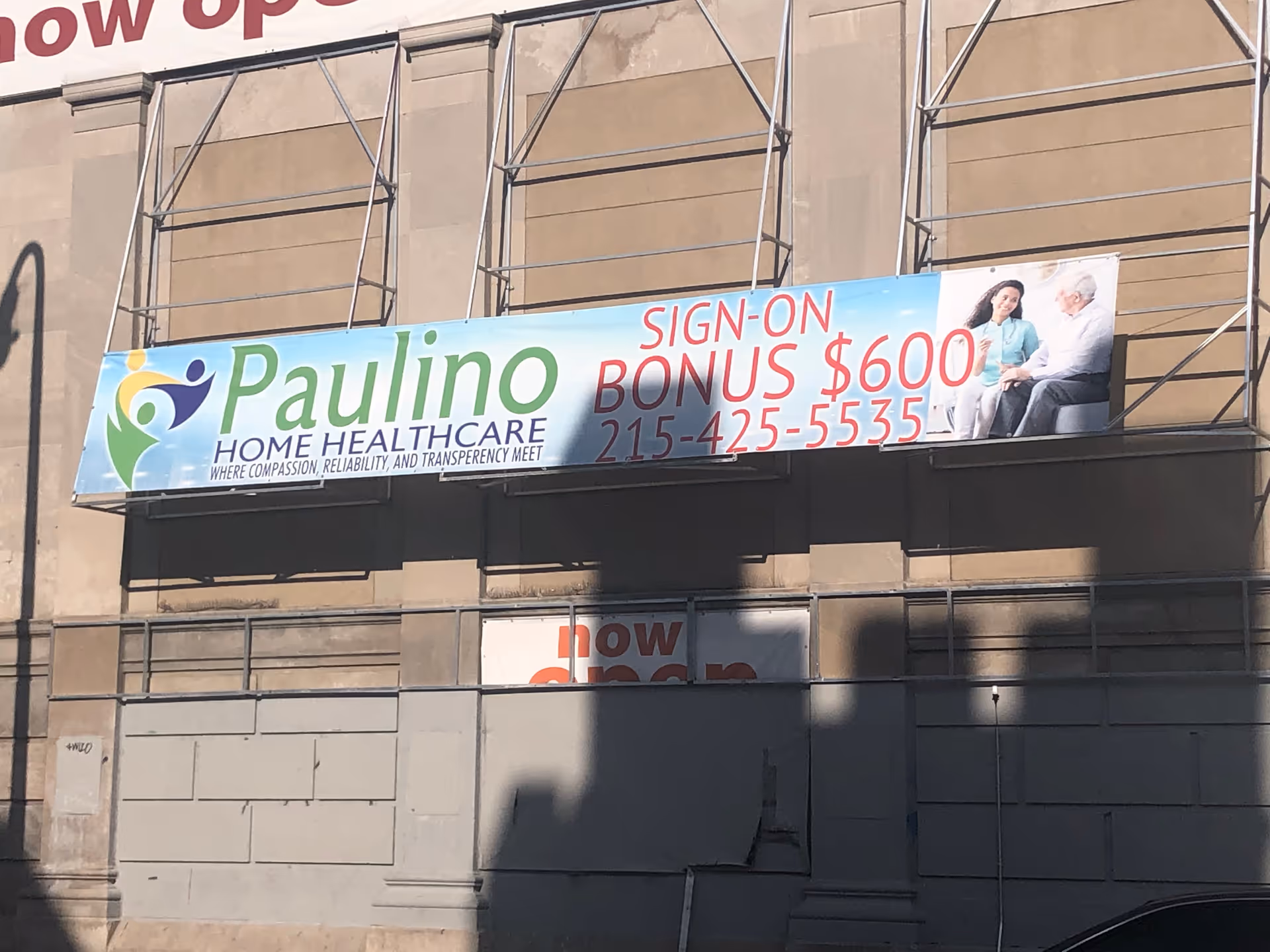 Building front with a large Paulino Home Healthcare banner across the facade.