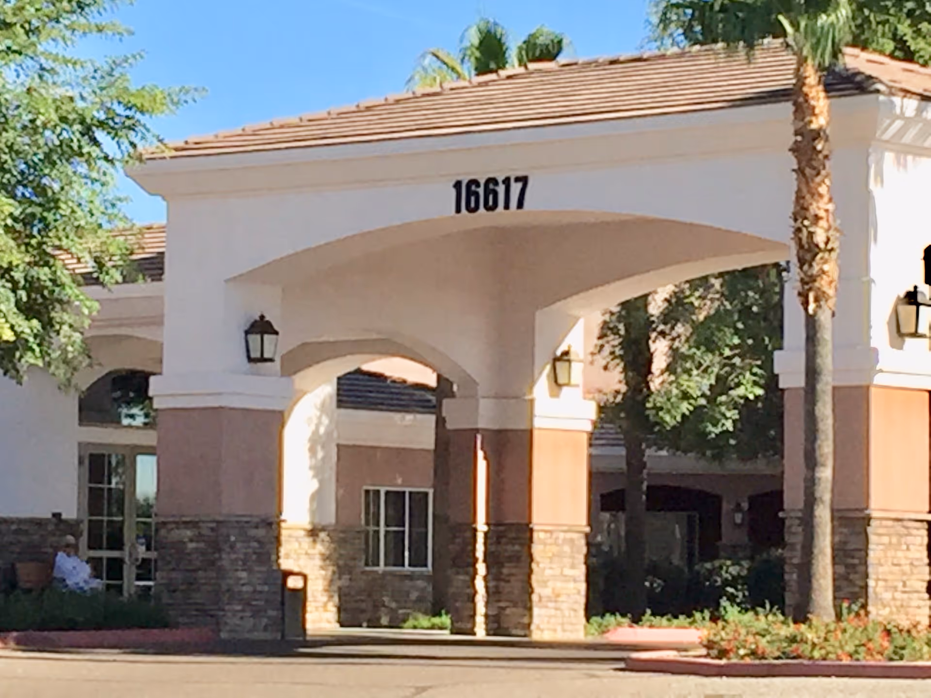Exterior view of Chaparral Winds entrance with arches, columns, and a visible address 16617.