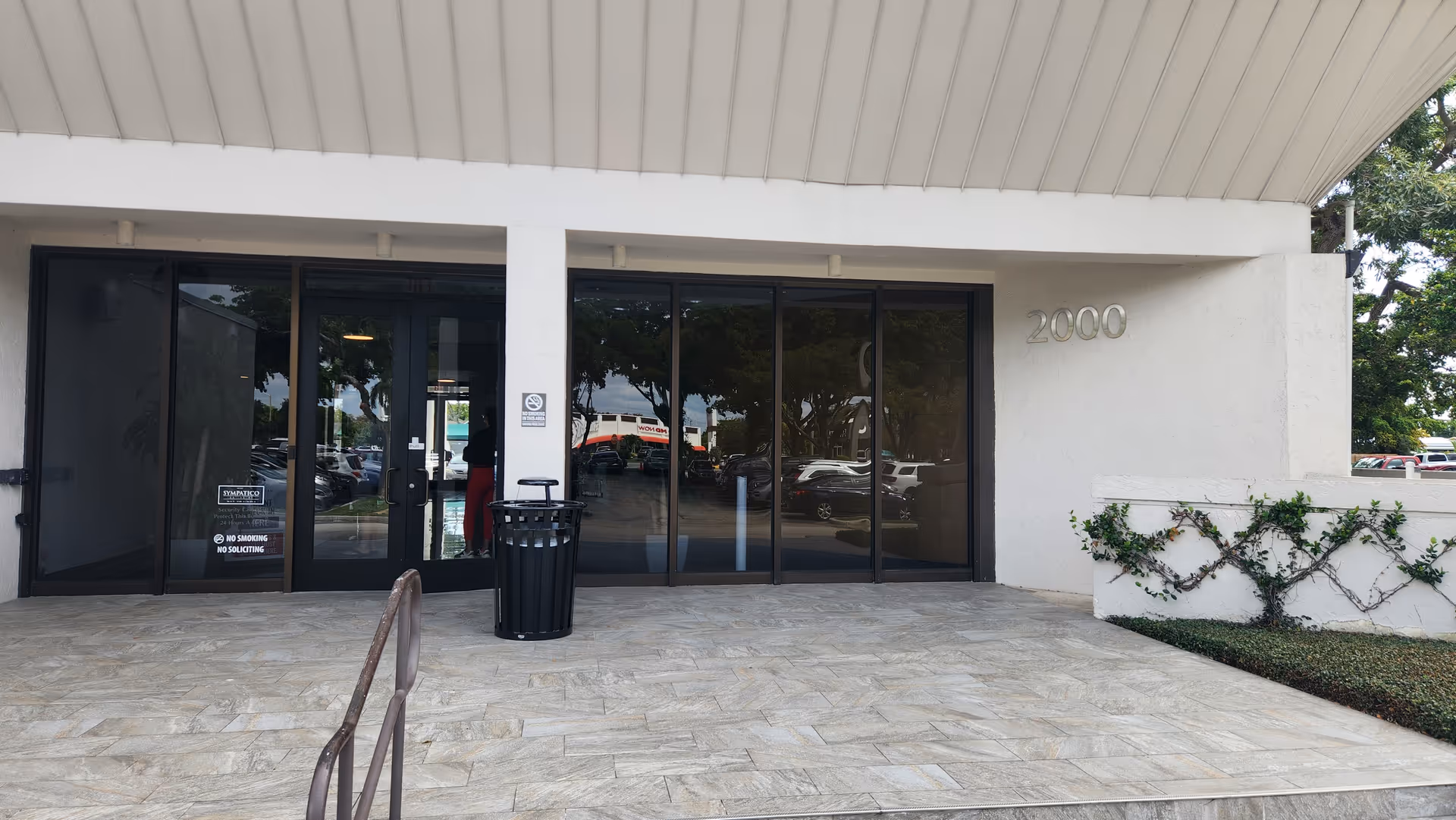 Exterior view of a senior care facility entrance with glass doors and the number 2000.