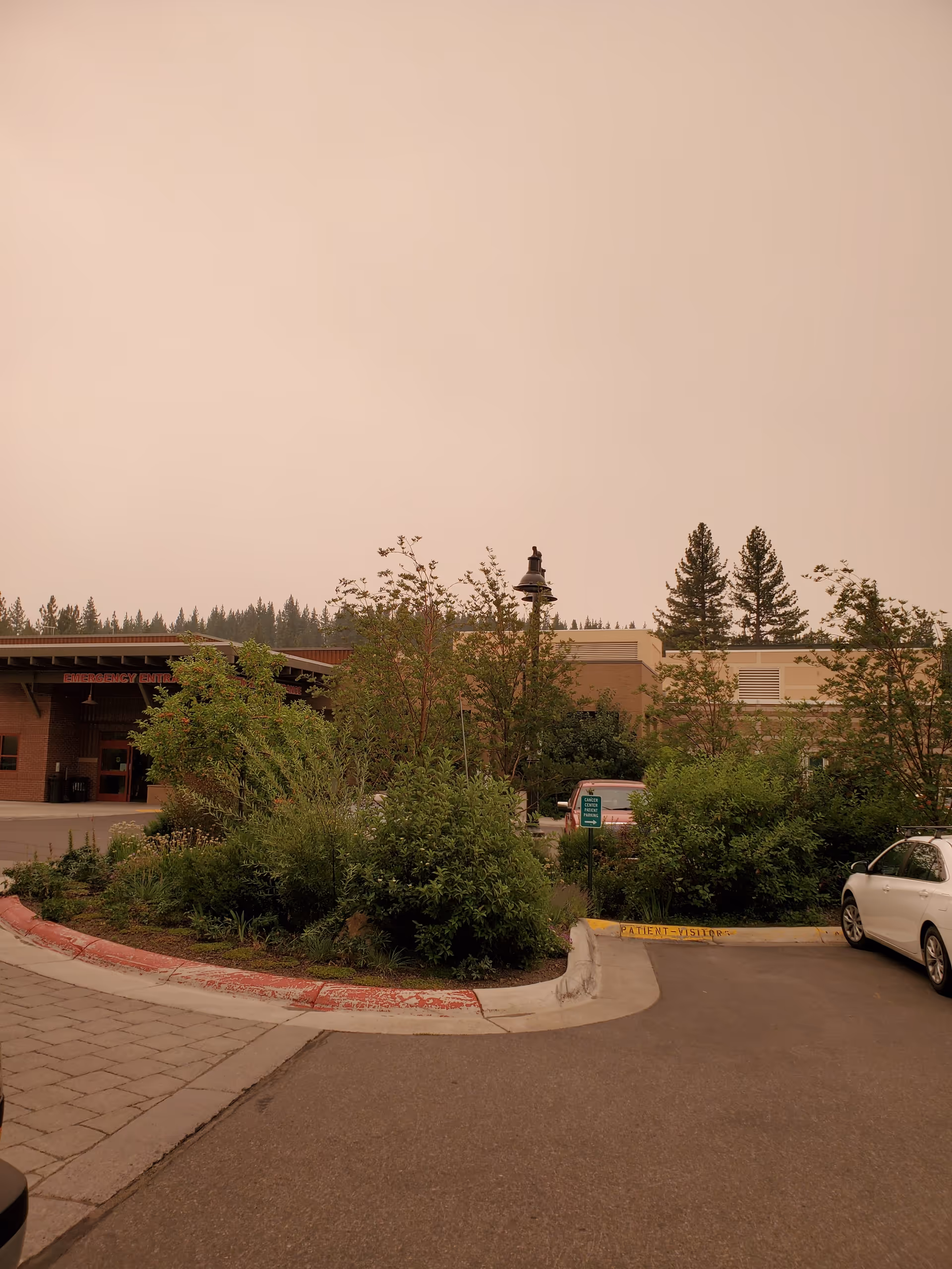 Exterior view of Tahoe Forest Hospital front with landscaping and parking.
