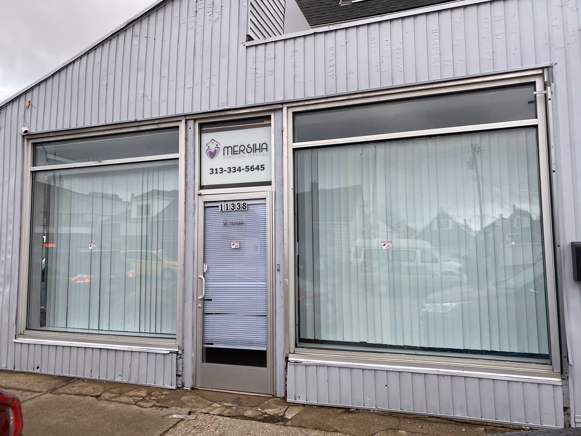 Grey storefront with large windows, glass door, and Mersiha Homecare Services sign.