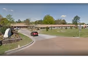 Exterior view of Grace Healthcare of Cordova, a long single-story senior care facility with circular driveway.