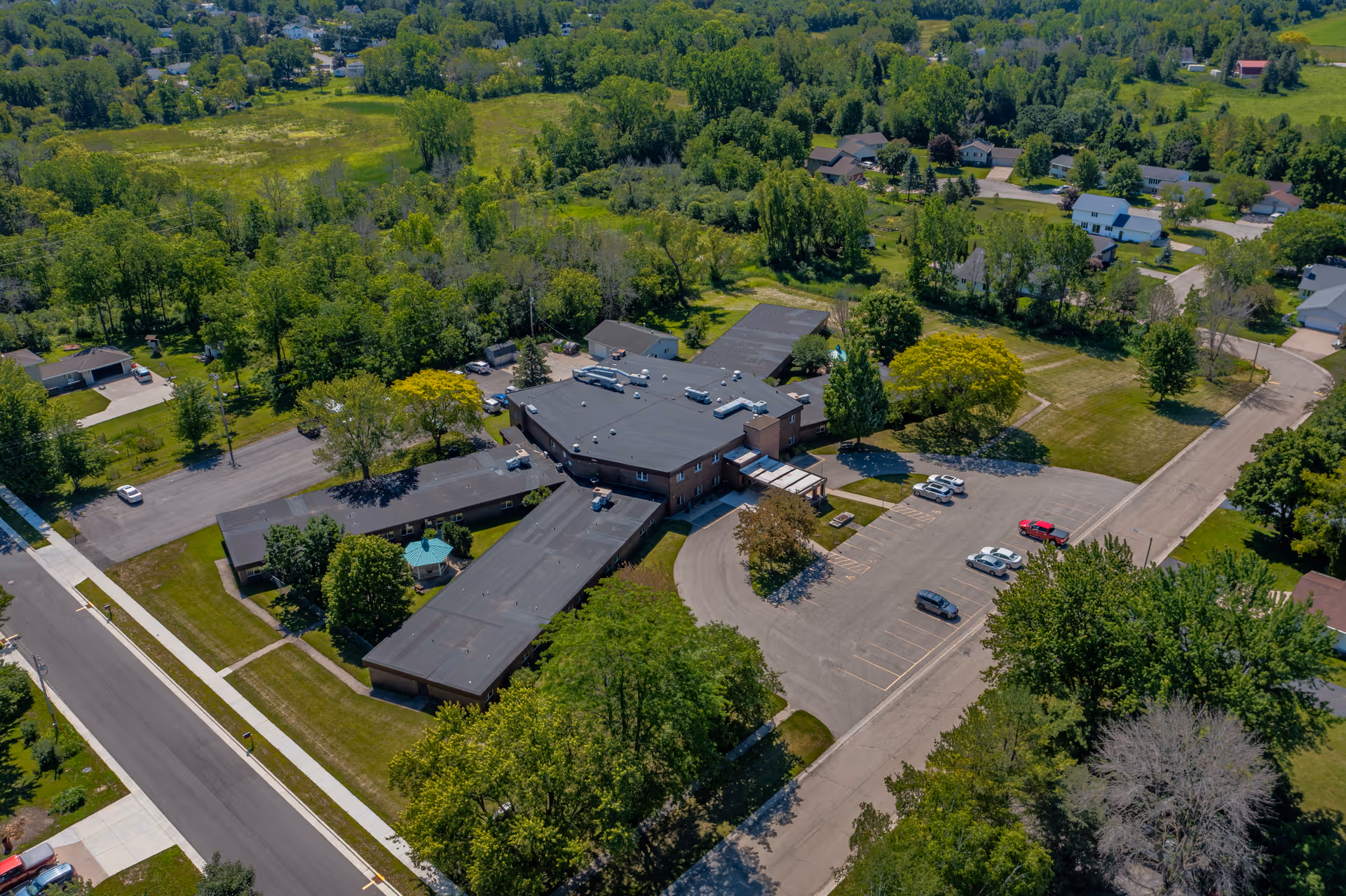 Aerial view of Omro Care Center campus with wings and surrounding greenery.