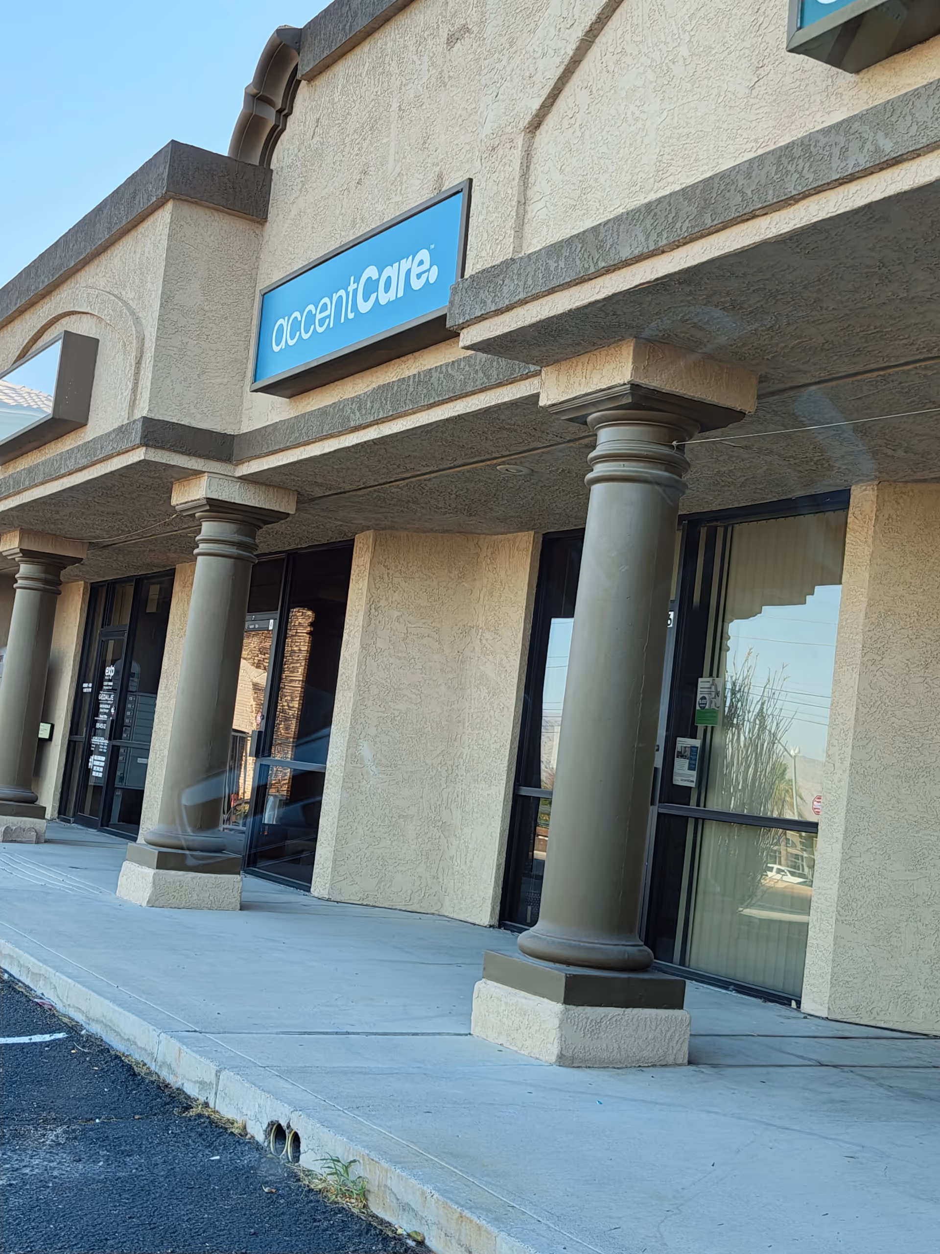 Exterior view of AccentCare facility with columns and glass entrance doors.