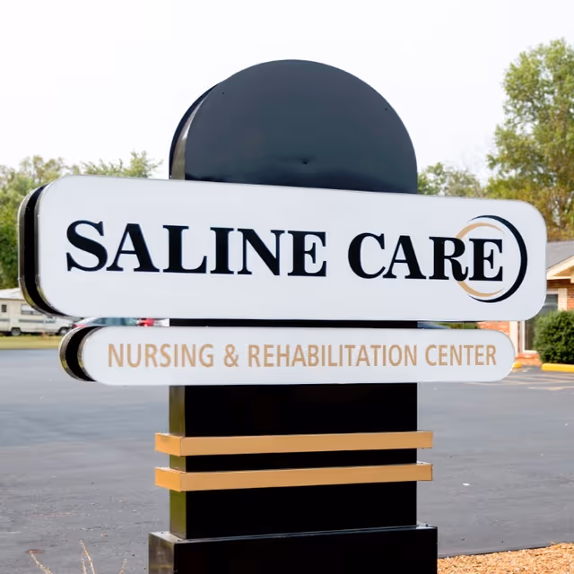 Outdoor view of Saline Care Nursing & Rehabilitation Center sign at the facility.