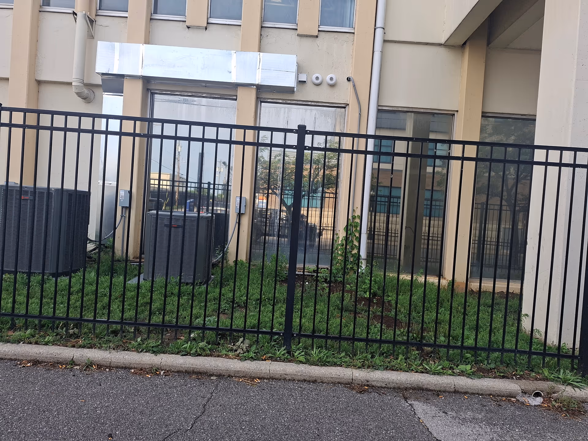 Exterior view of Noble Senior Living at Fort Wayne with a black metal fence.