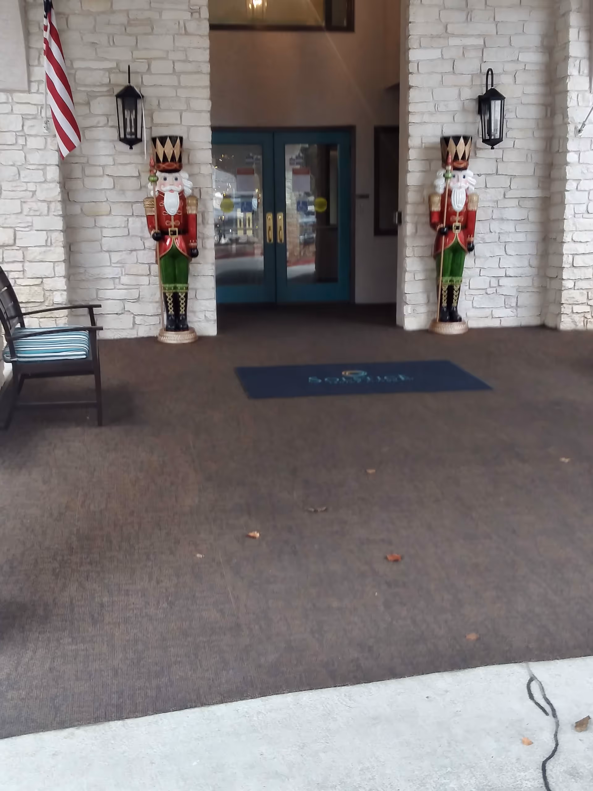Entrance to Solstice Senior Living at Austin with nutcracker statues and seating.