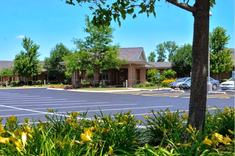 Exterior view of Lightways Hospice facility with brick building, parking lot, and landscaping.