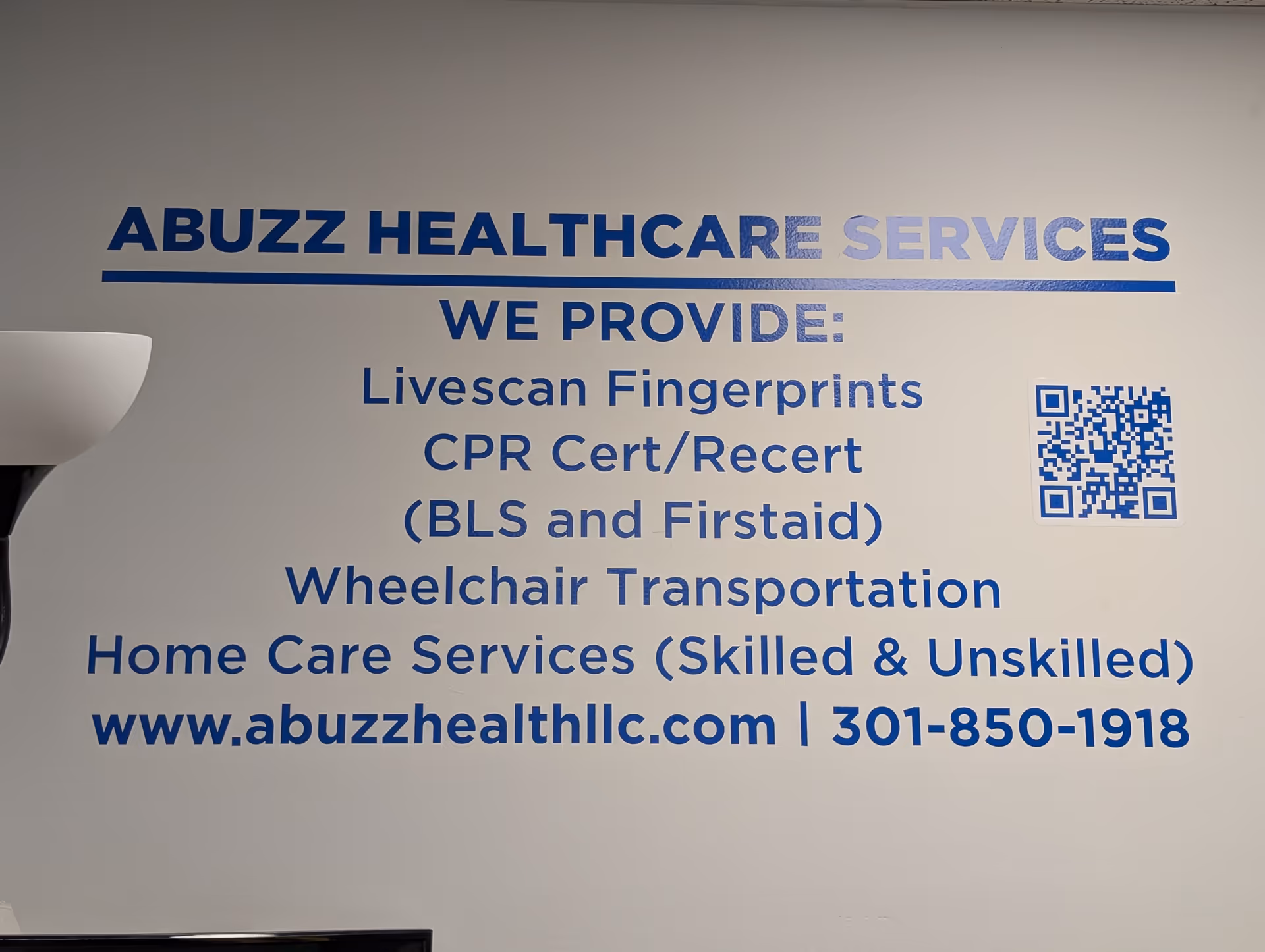 Interior wall with blue signage for Abuzz Healthcare Services and provided services.