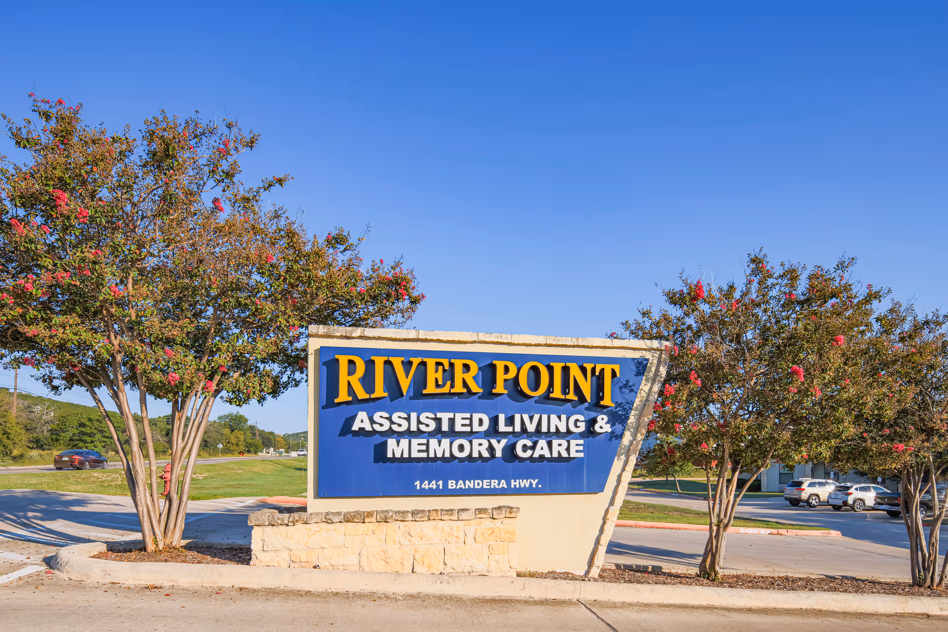 Exterior sign reading River Point Assisted Living & Memory Care at the entrance