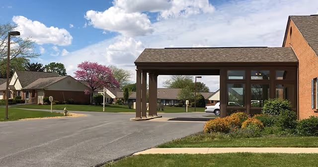 Exterior view of The Meadows of Leipsic with porte-cochere entrance and landscaped surroundings