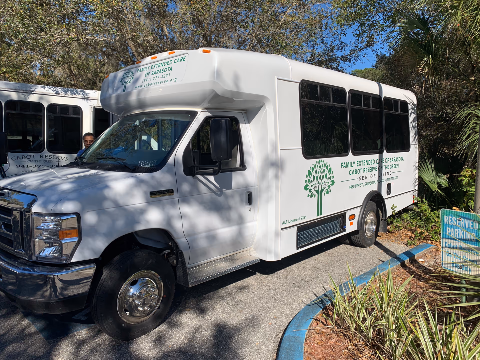 A white shuttle bus labeled Cabot Reserve on the Green parked outdoors.