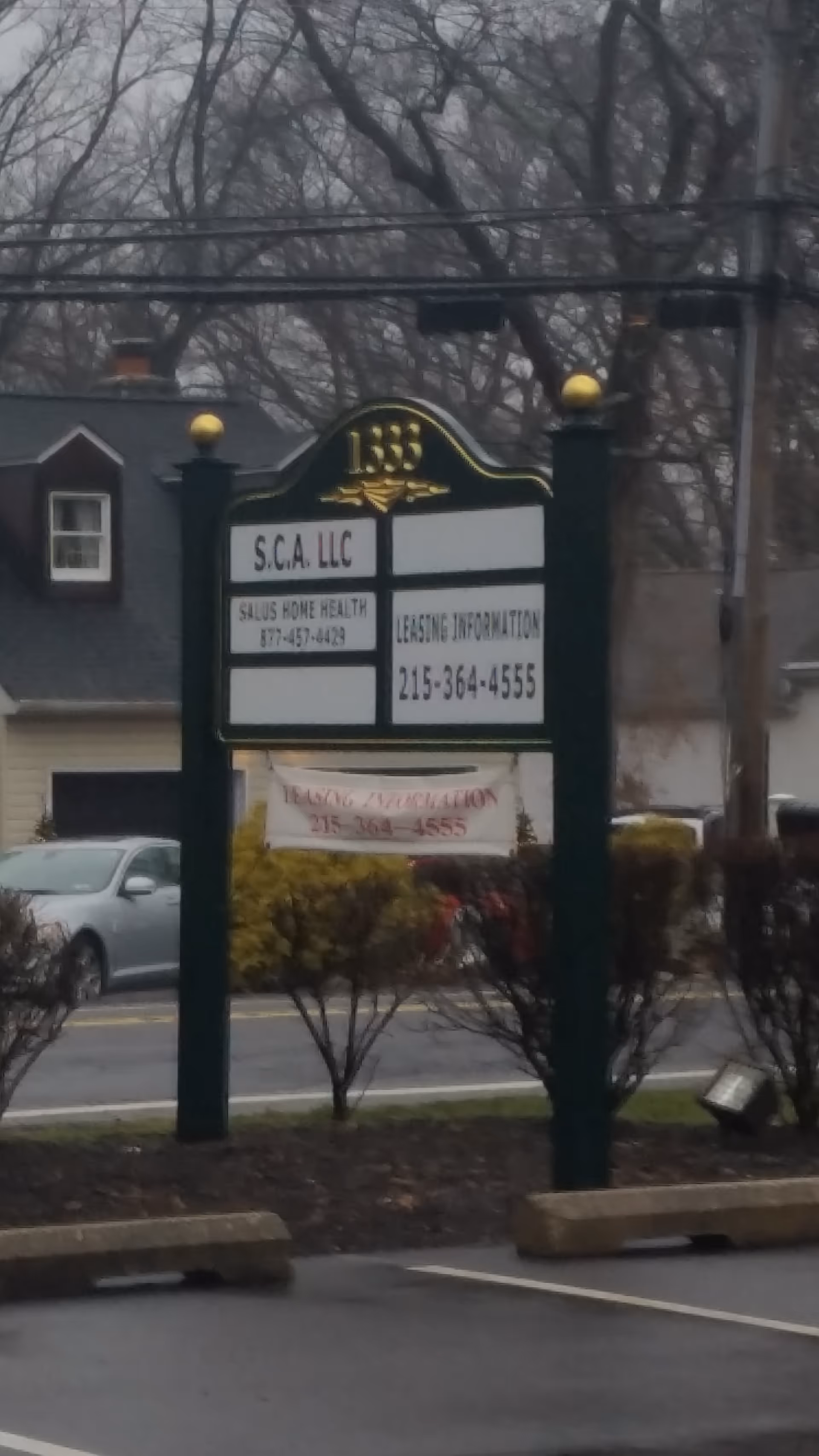 Exterior signboard advertising Salus Home Health in front of a building