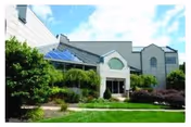 Exterior view of The Summit at Plantsville with landscaped entrance.