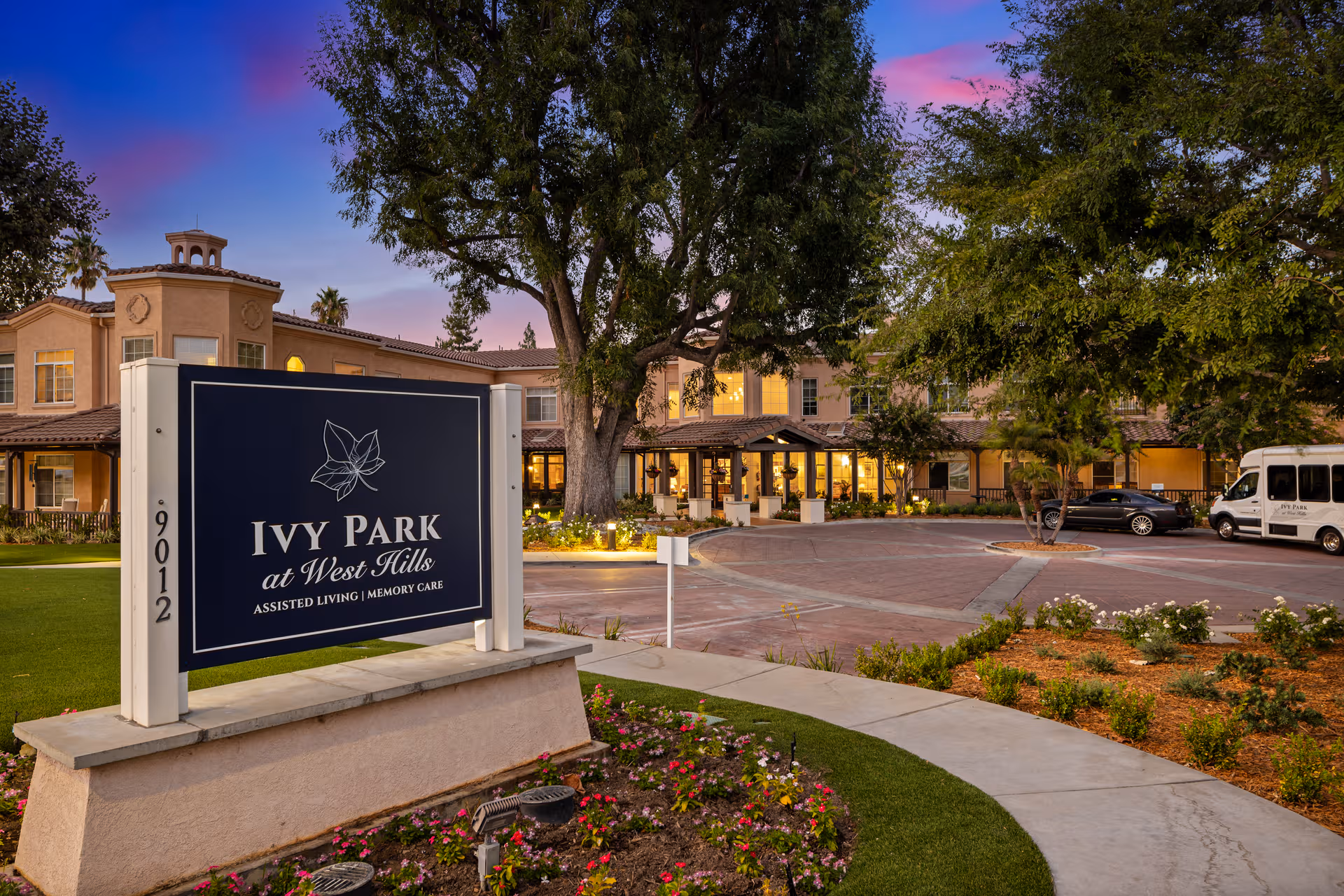 Exterior view of Ivy Park at West Hills with a large sign and surrounding landscaping.