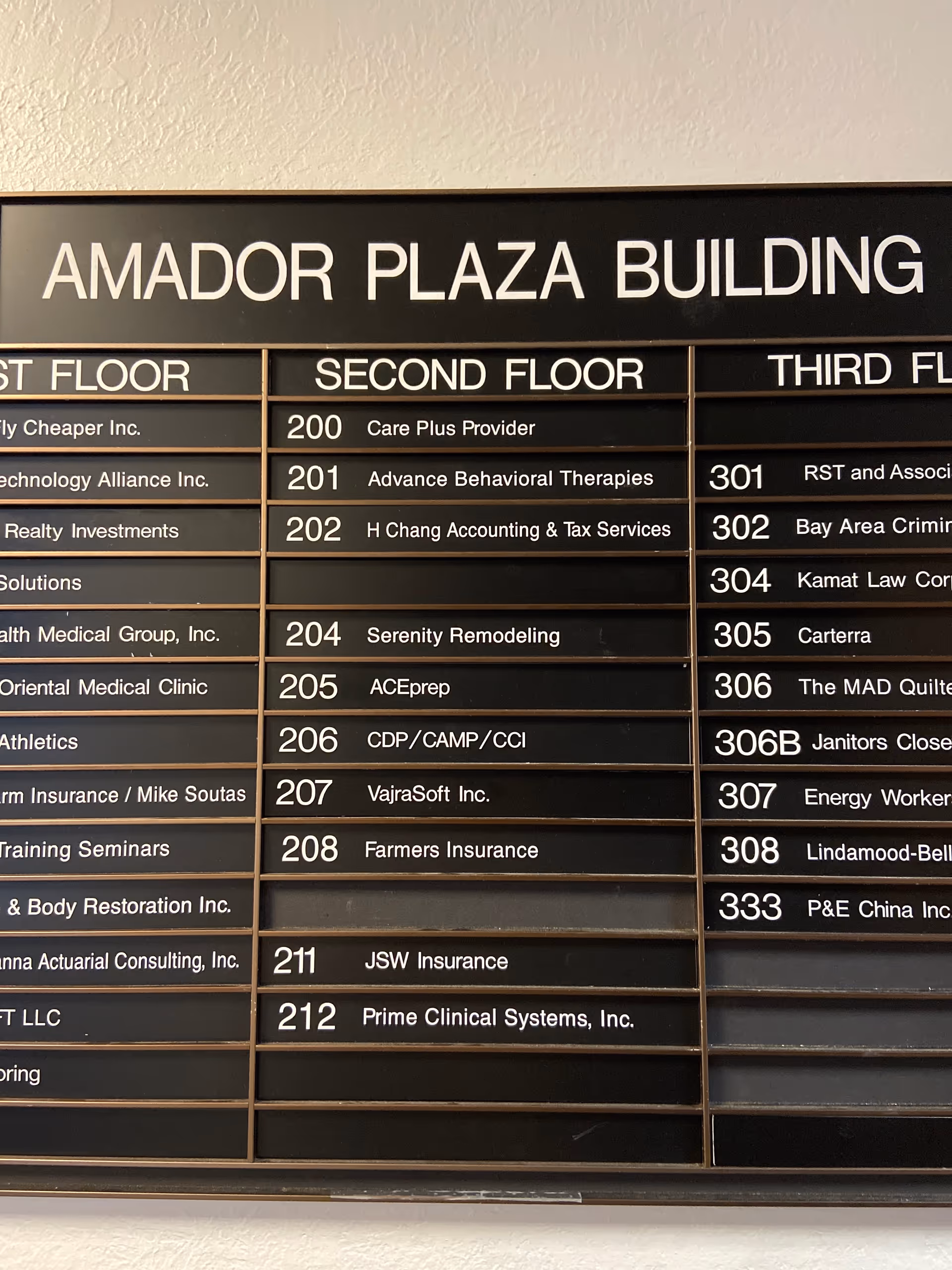 Interior building directory board listing tenants, including Care Plus Provider on the second floor.