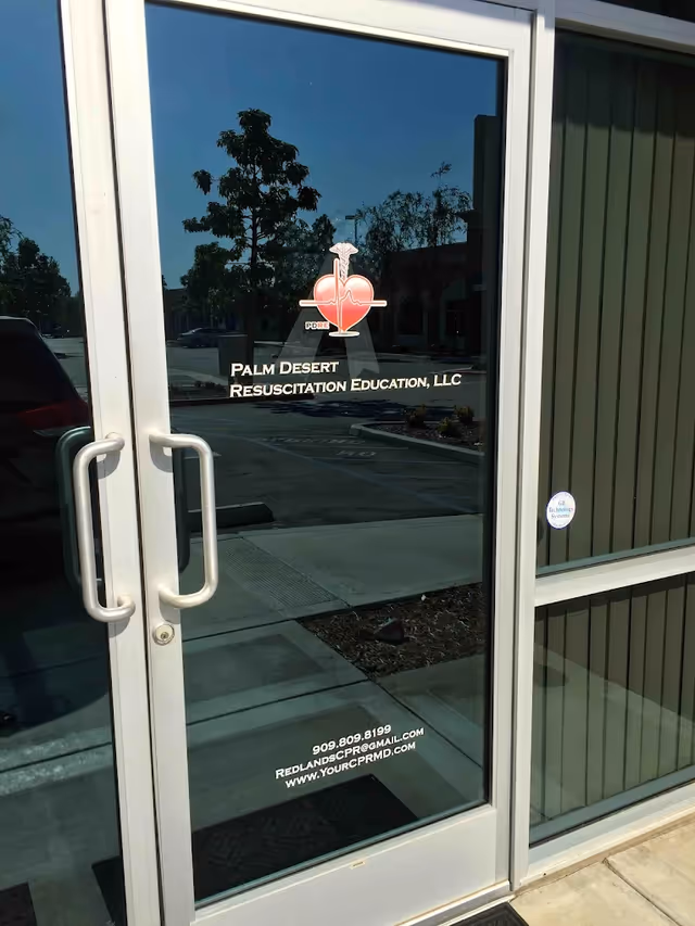 Front glass door with CPR Palm Desert Resuscitation Education logo and contact info