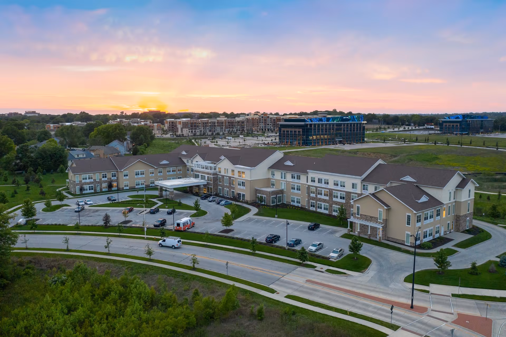 Exterior view of Alto Overland Park senior living campus with parking lot.