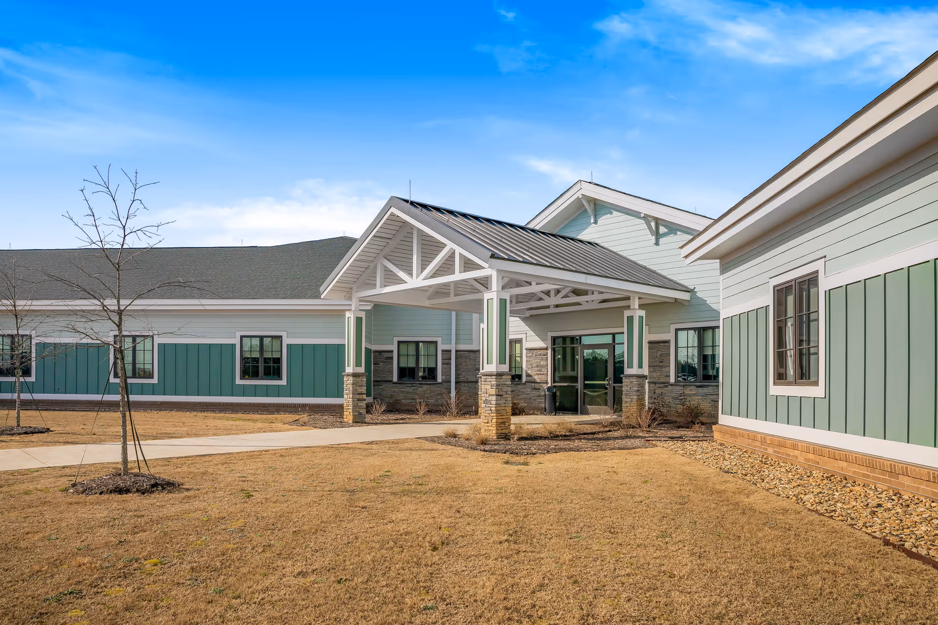 Exterior view of Palmetto Patriots Home with a covered entrance and dry lawn.